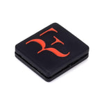 Antivibrador de Tenis Roger Federer Negro/Naranjo